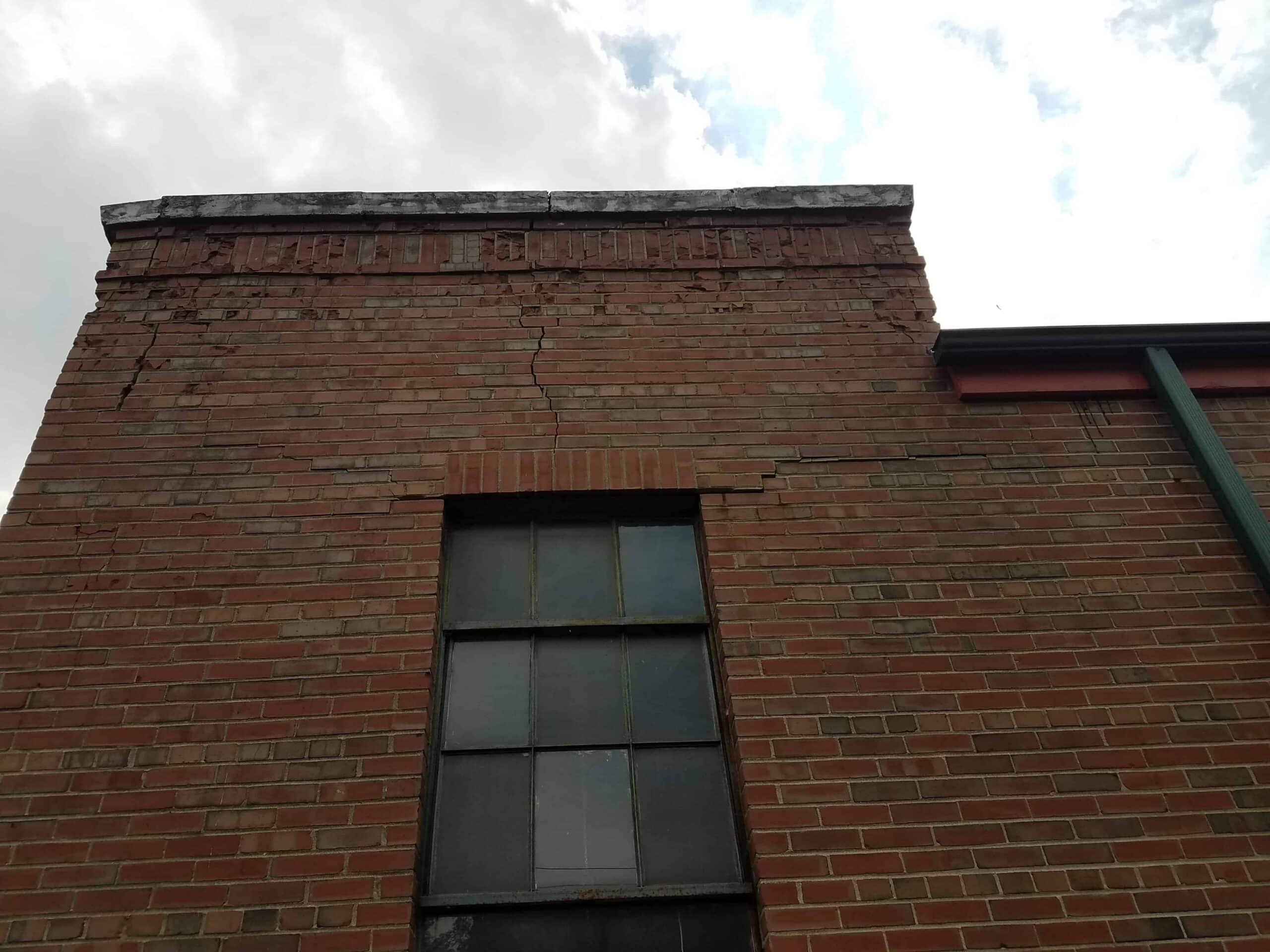 Exterior brick wall with large crack causing wall water damage picture