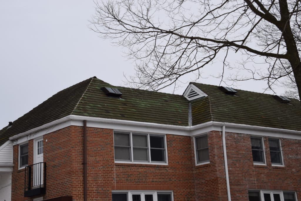 Apartment building roof analyzed by roofing consultants